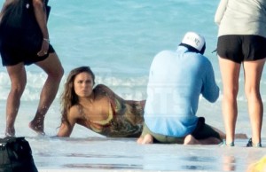 Ronda Rousey pictured on a sports Illustrated shoot with painted on swimsuit on a beach in the Bahamas