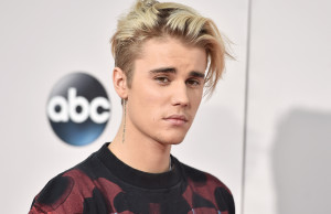 FILE - In this Sunday, Nov. 22, 2015 file photo, Justin Bieber arrives at the American Music Awards at the Microsoft Theater in Los Angeles. With his recent batch of hit singles and semi-grown-up sound  - including the electro-pop "Where Are U Now" with DJ-producers Skrillex and Diplo - adult men have begun attending the church of Bieber, and while some have issues admitting it, other proudly say they are Beliebers. Sorry and What Do You Mean, currently at Nos. 2 and 4 on Billboards Hot 100 chart, helped Bieber solidify his comeback after years of a broken image, which included arrests, public smoking and fainting onstage that led to hospitalization. (Photo by Jordan Strauss/Invision/AP, File)